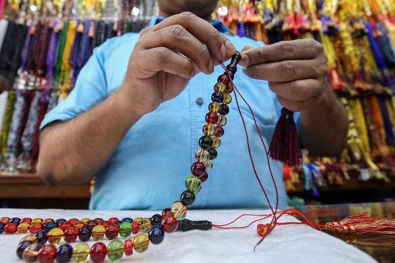 A vendor prepares prayer beads for sale at a market in Kuwait City during Ramadan.  AFP