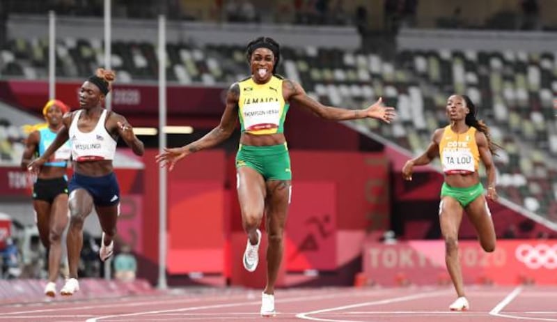 Jamaica's Elaine Thompson-Herah, centre, wins the women's 200m final.