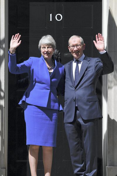 LONDON, ENGLAND - JULY 24: Outgoing Prime Minister Theresa May waves to the world's media beside husband Philip May from outside 10 Downing Street on July 24, 2019 in London, England. Theresa May has been leader of the Conservative Party since 13th July 2016. Today she makes her final statement to the country as British Prime Minister. Boris Johnson, MP for Uxbridge and South Ruislip, was elected leader of the Conservative and Unionist Party yesterday receiving 66 percent of the votes cast by Conservative party members. He is due to take the office of Prime Minister this afternoon. (Photo by Jeff J Mitchell/Getty Images)