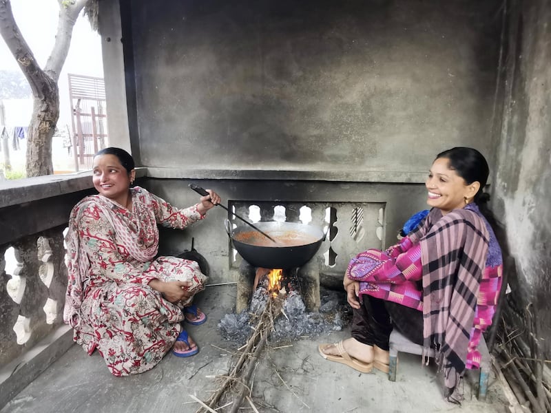 The women from Rauni village in Ludhiana in Punjab cook seasonal dessert on clay stove on the festival of Lohri. Amandeep Kaur (in pink) has picked the responsibility of looking after their farms in absence of her husband Narpinder Singh. Taniya Dutta for The National