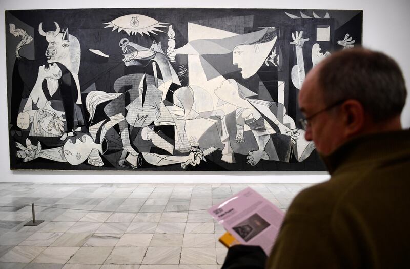 A man looks at Spanish artist Pablo Picasso's painting, "Guernica" at Reina Sofia museum in Madrid on March 24, 2017.
Close to 80 years ago, Picasso painted Guernica in a Paris attic, a haunting work of art that soon became a universal howl against the ravages of war, from 1937 Spain to 2017 Syria. / AFP PHOTO / PIERRE-PHILIPPE MARCOU / RESTRICTED TO EDITORIAL USE - MANDATORY MENTION OF THE ARTIST UPON PUBLICATION - TO ILLUSTRATE THE EVENT AS SPECIFIED IN THE CAPTION