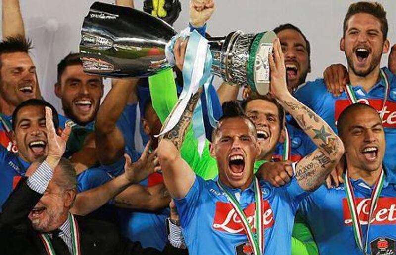 Napoli captain Marek Hamsik, centre, raises the cup after defeating Juventus in the Italian Super Cup final at the Al Sadd stadium in Doha, Qatar on December 22, 2014. EPA/STR