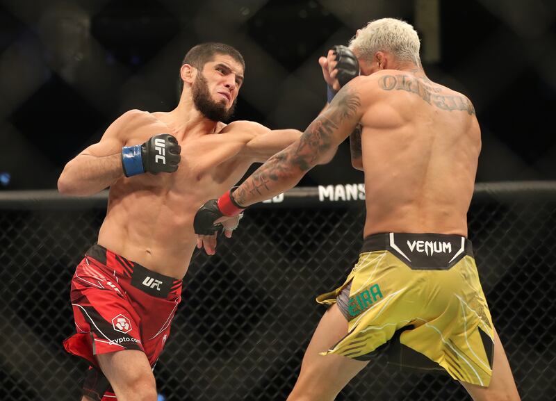 Islam Makhachev, left, and Charles Oliveira during their lightweight title fight at UFC 280 in Abu Dhabi. Chris Whiteoak / The National