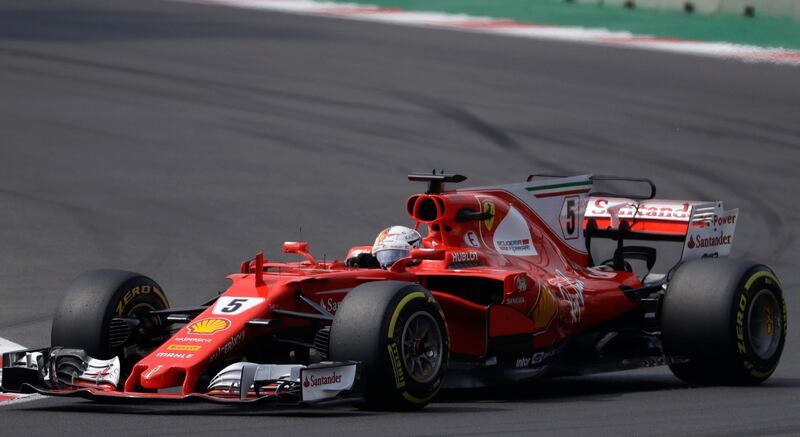 Ferrari driver Sebastian Vettel, of Germany, steers his car during the Formula One Mexico Grand Prix auto race at the Hermanos Rodriguez racetrack in Mexico City, Sunday, Oct. 29, 2017. (AP Photo/Rebecca Blackwell)