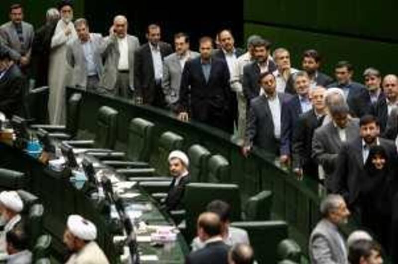 Iranian lawmakers queue to cast their votes for the cabinet list proposed by Iranian President Mahmoud Ahmadinejad at the parliament, in Tehran, Iran, Thursday, Sept. 3, 2009. Iran's conservative-dominated parliament approved most of President Mahmoud Ahamedinejad's choices for key Cabinet posts Thursday, including endorsing the defense minister nominee who is wanted by Argentina for a deadly 1994 bombing of a Jewish cultural center. (AP Photo/Vahid Salemi) *** Local Caption ***  VAH110_Mideast_Iran_Cabinet.jpg *** Local Caption ***  VAH110_Mideast_Iran_Cabinet.jpg