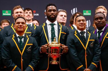 epa07969230 South Africa captain Siya Kolisi (C) holds the Webb Ellis Cup as South Africa head coach Rassie Erasmus (C-back) and World Rugby 15s Player of the Year nominee, Cheslin Kolbe (2-R) pose for a photo during their arrival for the World Rugby Awards in Tokyo, Japan, 03 November 2019. EPA/MARK R. CRISTINO