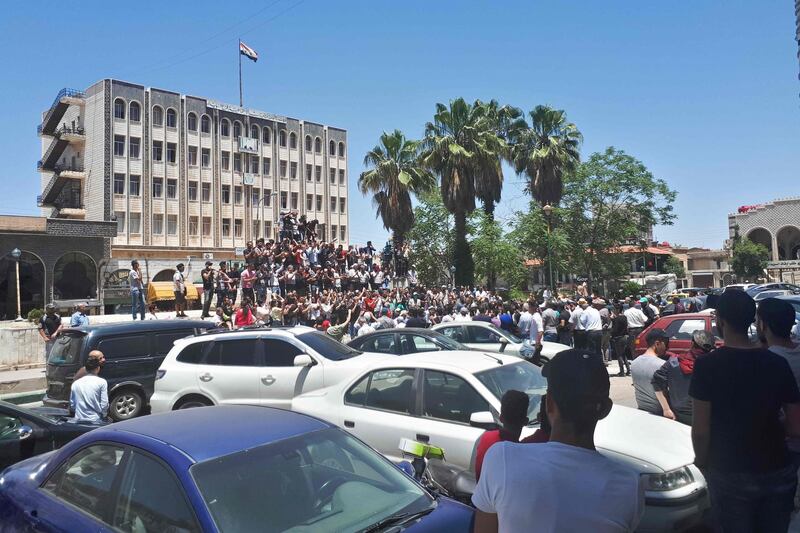 A handout picture released by the local news site Suwayda 24 shows Syrians chanting anti-government slogans as they protest the country's deteriorating economic conditions and corruption, in the southern city of Suwaida on June 9, 2020.  - == RESTRICTED TO EDITORIAL USE - MANDATORY CREDIT "AFP PHOTO / HO / SUWAIDA24" - NO MARKETING NO ADVERTISING CAMPAIGNS - DISTRIBUTED AS A SERVICE TO CLIENTS ==
 / AFP / SUWAYDA24 / - / == RESTRICTED TO EDITORIAL USE - MANDATORY CREDIT "AFP PHOTO / HO / SUWAIDA24" - NO MARKETING NO ADVERTISING CAMPAIGNS - DISTRIBUTED AS A SERVICE TO CLIENTS ==
