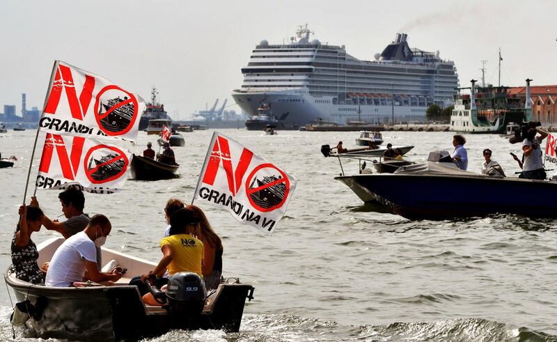 Environmental protesters from the No Grandi Navi group, demonstrate against the presence of cruise ships in the Venice Lagoon, as the 'MSC Orchestra' leaves the Italian city. AFP