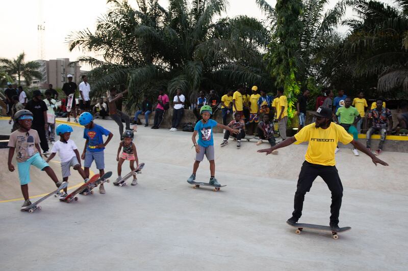 Joshua Odamtey, right, a sports coach, trains young skateboarders at the Freedom Skatepark.