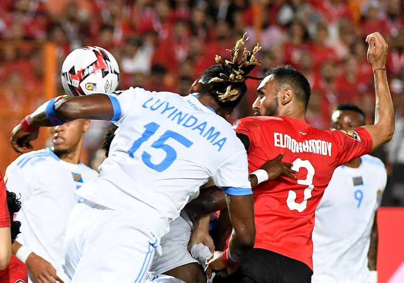 DR Congo defender Christian Luyindama fights for the ball with Egypt defender Ahmed Elmohamady. AFP