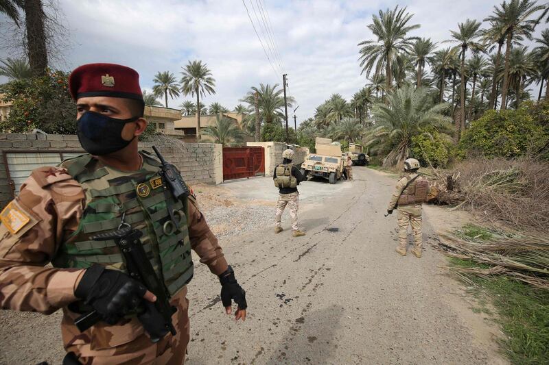 Iraqi forces search the area in Tarmiyah, 35 kilometres north of Baghdad, following clashes with ISIS fighters. Two security personnel and five insurgents died in the fighting.  AFP