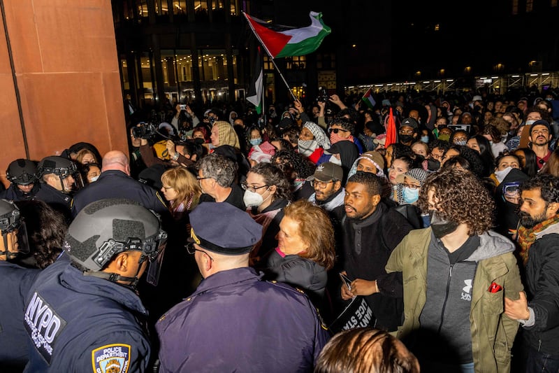 Police officers detain pro-Palestinian students and protesters at New York University. AFP