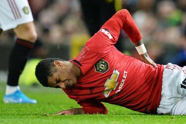 Marcus Rashford clutches his back during Manchester United's FA Cup replay against Wolves. EPA