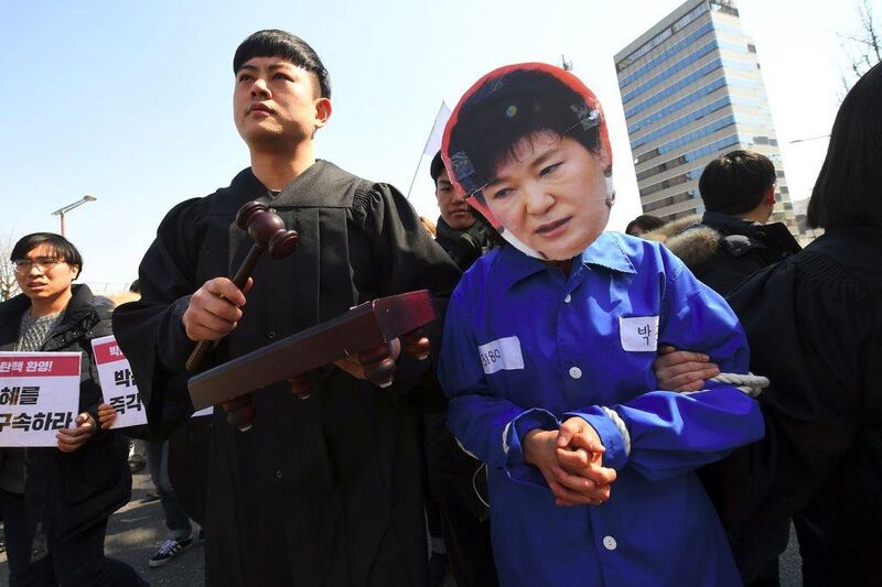 Anti-government activist, with one wearing a mask of South Korea's president Park Geun-hye, march toward the presidential Blue House after the announcement of the Constitutional Court's decision to uphold the impeachment of Park in Seoul on March 10, 2017, over a wide-ranging corruption scandal. Jung Yeon-Je / AFP

