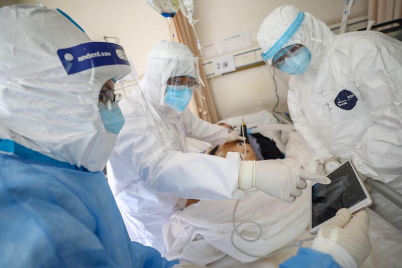 Medical personnel check the conditions of a COVID-19 patient at a hospital in Wuhan, Hubei province, China.  EPA