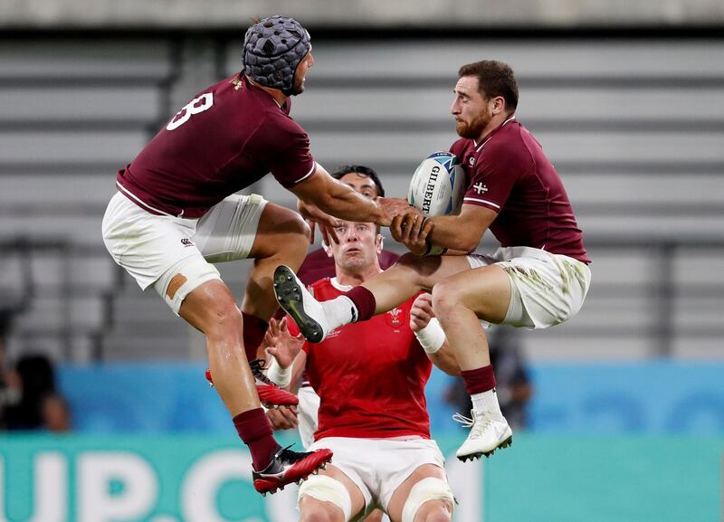 Wales' Alun Wyn Jones, centre is baten to the ball by Georgia's Beka Gorgadze and Vasil Lobzhanidze. Reuters