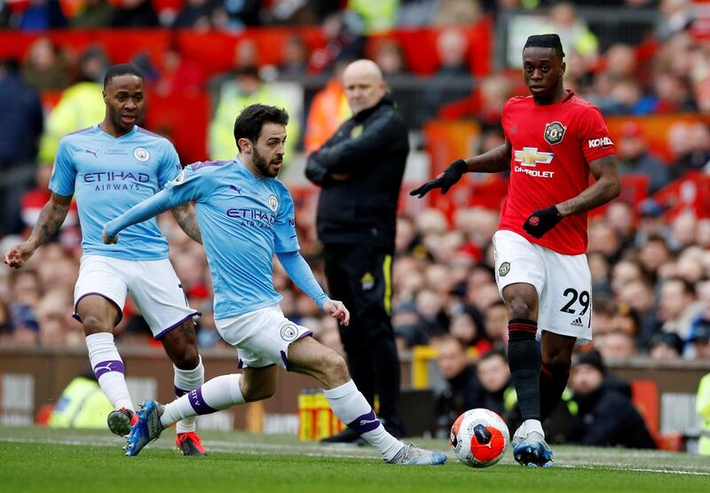 Manchester United's Aaron Wan-Bissaka, right, in action with Manchester City's Bernardo Silva . Reuters