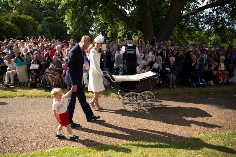 Prince George walks with his parents Prince William and Kate, as they arrive at the Sandringham Estate for the Christening of Princess Charlotte in 2015. Getty Images