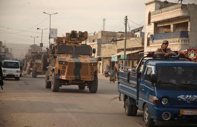 Turkish military vehicles drive in a convoy headed for the south of Idlib province as they pass by the town of Atareb in the western countryside of Aleppo.   AFP