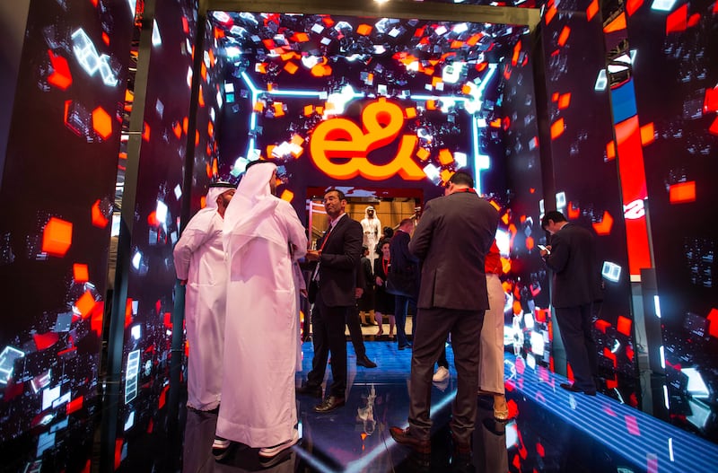 Visitors at the e& stand at Gitex Technology Week in Dubai World Trade Centre. Leslie Pableo / The National