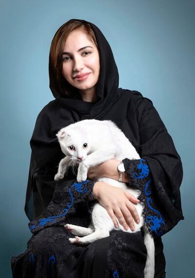 Manal Al Mansoori helps to feed stray cats in Dubai. Courtesy: Yanni Animal Welfare