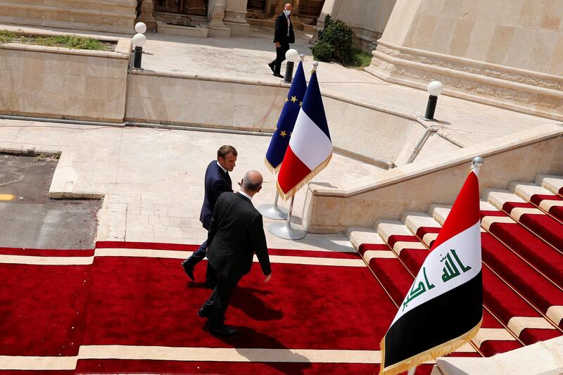 Iraq's President Barham Salih walks with French President Emmanuel Macron during a welcome ceremony at the Green Zone in Baghdad. REUTERS