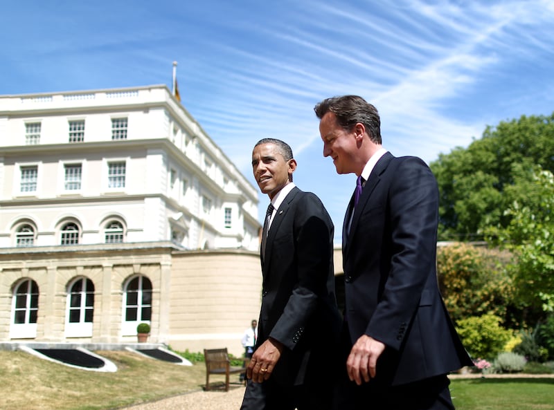 Mr Cameron and US President Barack Obama walk in the gardens of Lancaster House in 2011. Getty Images