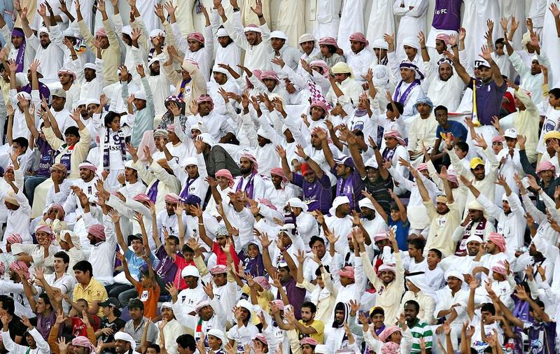 Football fans wave in Al Ain. Pawan Singh / The National