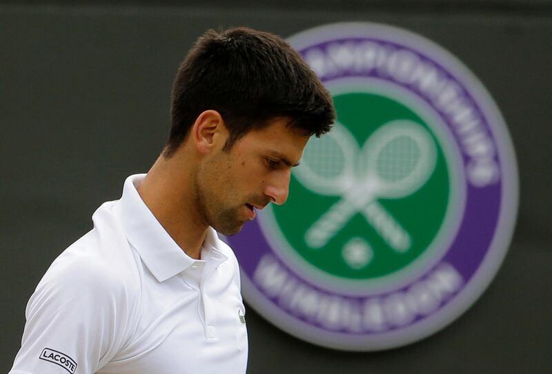 FILE - In this Wednesday, July 12, 2017 file photo Serbia's Novak Djokovic pauses before serving to Czech Republic's Tomas Berdych during their Men's Singles Quarterfinal Match on day nine at the Wimbledon Tennis Championships in London. (AP Photo/Alastair Grant, File)