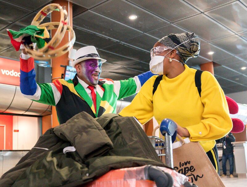 A traveler arriving on the first international commercial flight to land in South Africa since lockdown is welcomed at Cape Town International Airport, South Africa. EPA