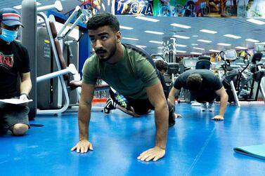 Hamad Nawad goes through his workout watched by coach Ramon Lemos at the resident camp at the Armed Forces Club in Abu Dhabi. Courtesy UAEJJF.