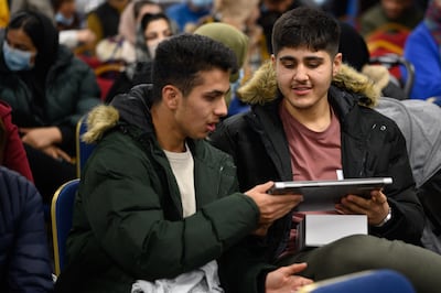 Members of the Afghan community receive free digital devices during the launch of the New Afghan Diaspora Council on December 01, 2021 in Feltham, England. Getty