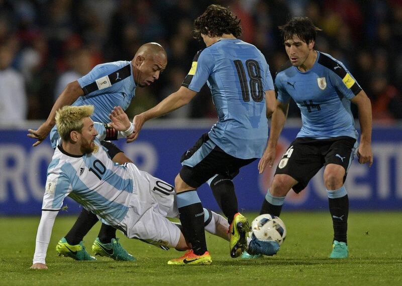Argentina's Lionel Messi fights for the ball with Uruguay's Egidio Arevalo Rios, Mathias Corujo and Nicolas Lodeiro. Juan Mabromata / AFP