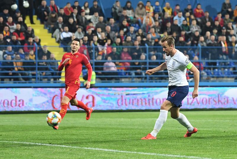 PODGORICA, MONTENEGRO - MARCH 25:  Harry Kane of England scores his team's fourth goal during the 2020 UEFA European Championships Group A qualifying match between Montenegro and England at Podgorica City Stadium on March 25, 2019 in Podgorica, Montenegro. (Photo by Michael Regan/Getty Images)