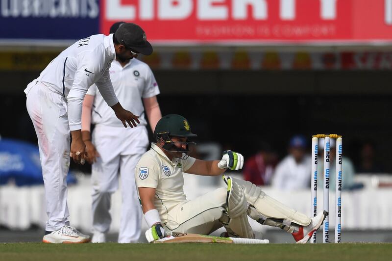 South Africa's Dean Elgar sits on the floor after being hit by a ball while batting. AFP