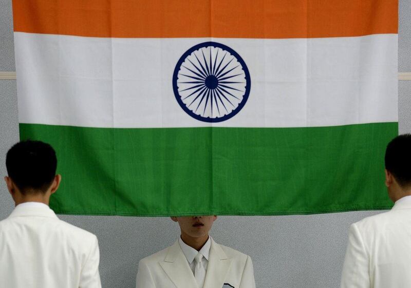The Indian national flag gets raised at the medal ceremony for the men's 50 metre pistol, the event Jitu Rai took gold in, at the 2014 Asian Games. Manan Vatsayana / AFP / September 20, 2014