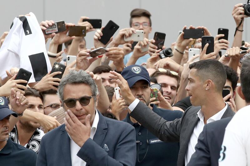 Ronaldo greets his supporters outside the Juventus medical center. AFP