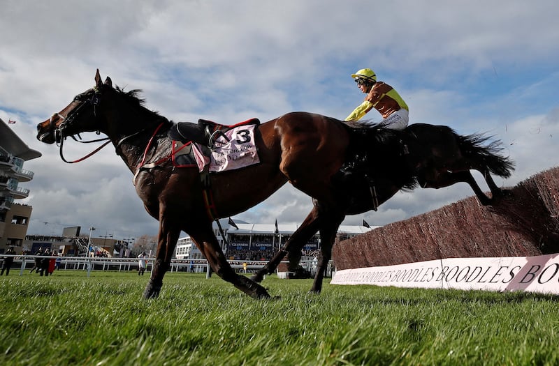 Galopin Des Champs, ridden by Paul Townend, navigates a riderless horse, Fastorslow, to win the Cheltenham Gold Cup in Gloucestershire, UK. Reuters