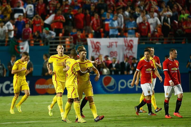 Steven Gerrard of Liverpool is congratulated by his teammates for scoring a penalty kick against Manchester United in the first half of the Guinness International Champions Cup 2014 Final at Sun Life Stadium on August 4, 2014 in Miami Gardens, Florida. Chris Trotman/Getty Images