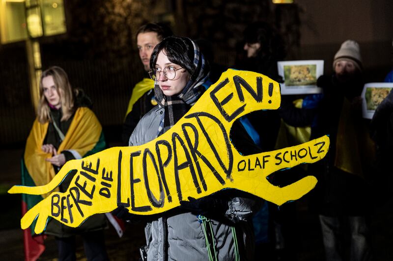A protester holds a sign that reads 'Free the Leopards, Olaf Scholz' as demonstrators, many of them expatriate Ukrainians living in Berlin, protest outside the Chancellery. Getty