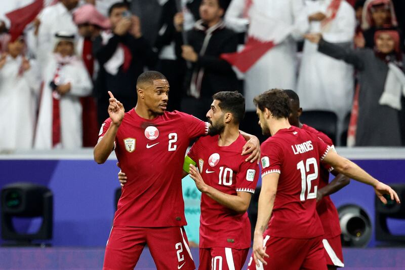 Qatar's players celebrate their team's first goal. AFP