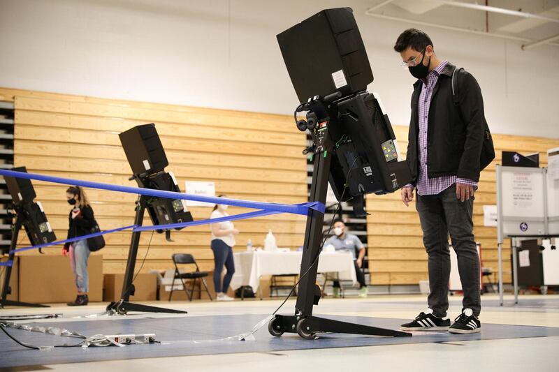 Julian Belilty, from the Kalorama neighbourhood of the District of Columbia, casts his early vote at the Marie Reed Elementary School in the Adams Morgan Neighborhood in Washington, U.S..  Reuters