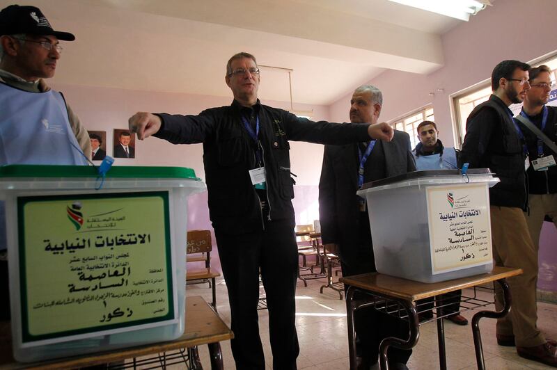 David Martin, chief observer of European Union Election Observing Mission (EU EOM) to Jordan, gestures at a polling station in Amman January 23, 2013. Polling stations opened on Wednesday in Jordanian elections boycotted by the Muslim Brotherhood, which says the electoral system is rigged in favour of tribal areas and against the large urban centres. Eyewitnesses reported queues of about a dozen people apiece at several polling stations across the kingdom just before the polls opened at 7 a.m. (0400 GMT).    REUTERS/Ali Jarekji  (JORDAN - Tags: POLITICS ELECTIONS) *** Local Caption ***  AMM07_JORDAN-ELECTI_0123_11.JPG