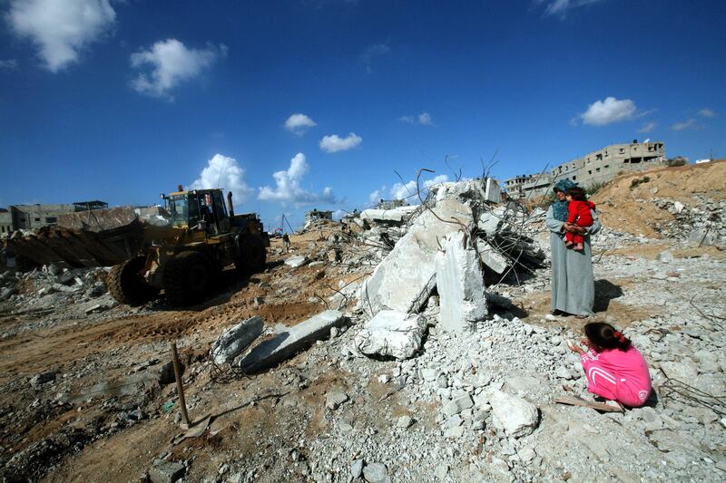 epa01974547 Ebtesam Khader, 35, holds her baby as she looks at the remains of her house that was destroyed during the military conflict between Israel and Hamas that took place during the winter of 2008?2009, at the Jabaliya Refugee Camp, in the Gaza Strip, 13 November 2009. The familiy with seven daughters now lives in a tent without electricity or main supplies. The Operation Cast Lead led by the Israeli forces started on 27 December 2008 and ended on 18 January 2009. The attacks included the entire Gaza Strip but mainly focused on Gaza City, targeting the infrastructure of the Hamas movement and its government buildings. According to the Gaza Ministry of Health, hundreds of Palestinians lost limbs during the offensive, many of them children and women. Most of the patients need medical treatment abroad because of the lack of medical equipment and staff expertise. The Gaza-based Al Mezan Center for Human Rights reports that some 1,410 Palestinians were killed, including 355 under the age of eighteen. The center further reports that the Israeli forces destroyed or damaged thousands of homes and housing units leaving many people homeless or living in tents. A United Nations report on the offensive in October 2009 concluded that both the Israeli Defense Forces and Palestinian armed groups committed war crimes and possible crimes against humanity. Both sides have denied the report.  EPA/ALI ALI *** Local Caption *** 01974547