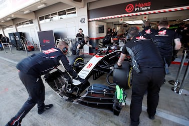 Haas' Romain Grosjean is pushed into the pits during the pre-season testing in Barcelona. Reuters