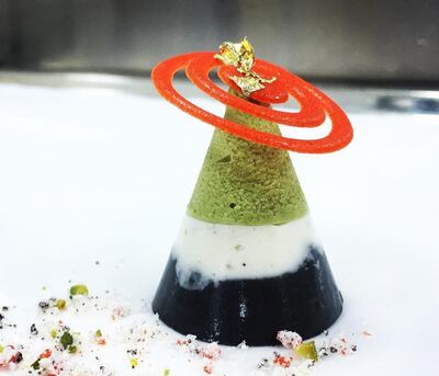A three-layered dessert with sesame, cardamom, pistachio and raspberry tuile - done in colours of the UAE flag - will end the meal on a sweet note. Photo: Jubilee Gastronomy