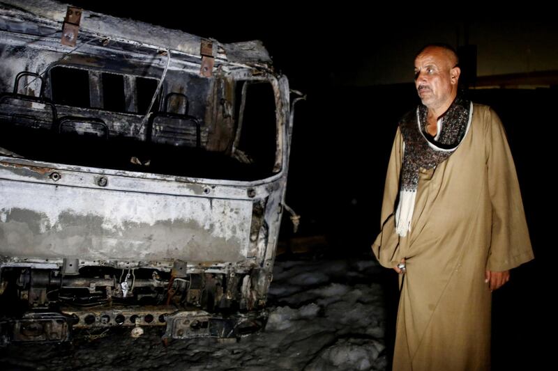 A man stands near burned vehicles following a fire that broke out in the Shuqair-Mostorod crude oil pipeline, on the Cairo-Ismailia road, in Egypt. A ruptured crude oil pipeline set off a monstrous blaze on a desert highway in Egypt on Tuesday, injuring at least 17 people, local authorities said. AP Photo