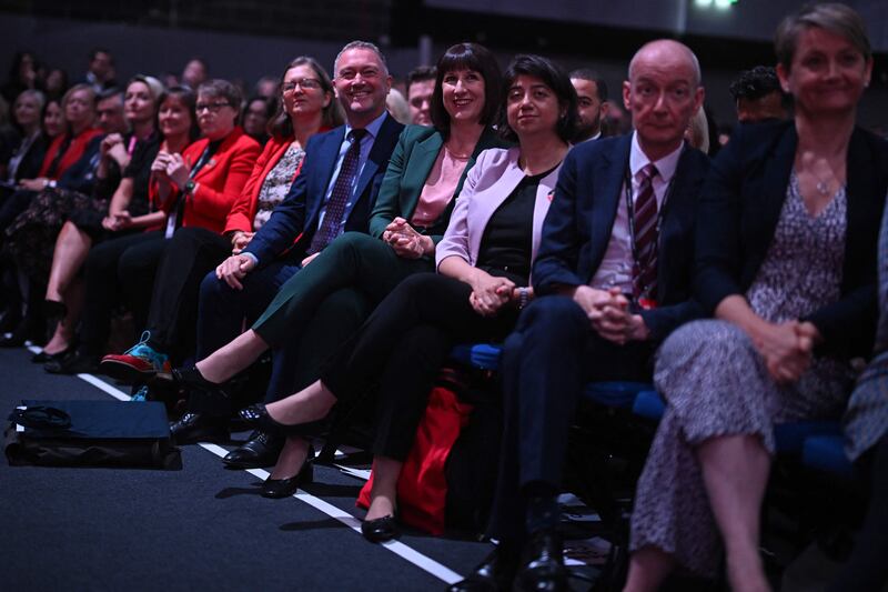 Ms Reeves, fourth from right, and shadow cabinet colleagues listen to a speech from Ms Rayner. AFP