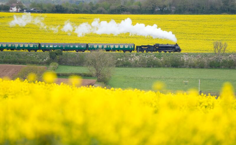 A steam train makes its way along the Mid Hants Railway, also known as the Watercress line, near Ropley in Hampshire. PA