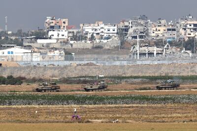 Israeli military vehicles manoeuvre near the border with Gaza in Israel. Reuters